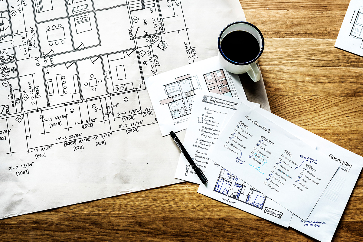 coffee cup on top of blueprints